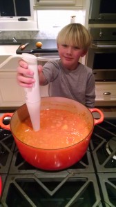 Assistant soup maker William using an immersion blend to puree the soup into a perfectly smooth and silky consistency. 
